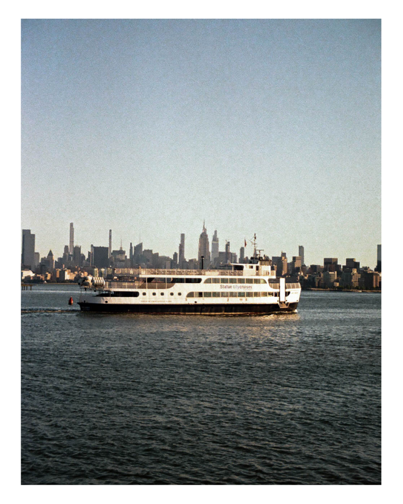 This is a photograph of a 35MM film photo of a public ferry trolling across the NYC basin. In the background there is the NYC skyline. 

This was just a beautiful photo to capture the moment and the essence of NYC on a chilly October Morning. 